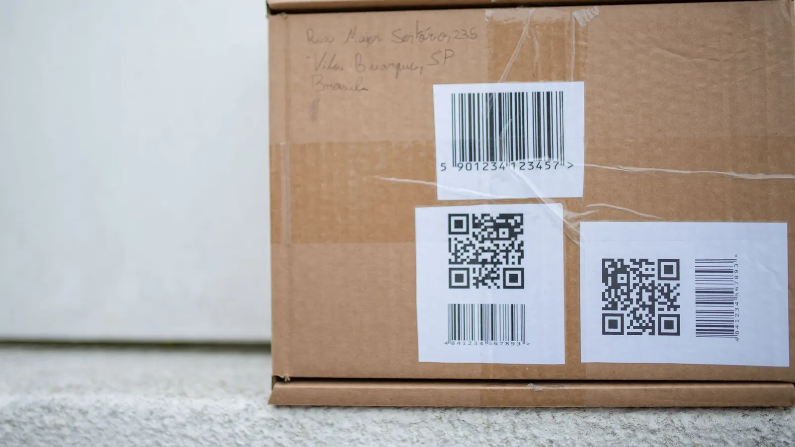 Cardboard box with printed barcode and QR code labels